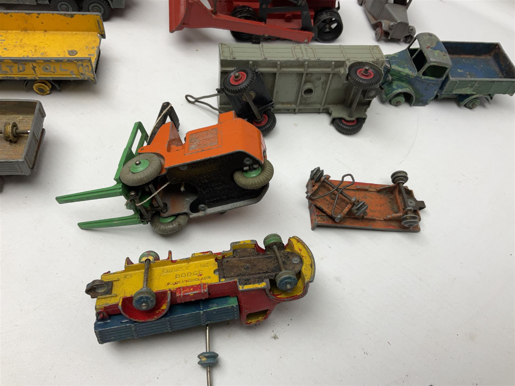 Dinky - twenty-six unboxed and playworn die-cast models including Foden Regent Tanker, two Foden lorries, Pressure Refueller No.642, Snow Plough, Elevator Loader, Foden Dump Truck, Blaw Knox Bulldozer and other commercial vehicles