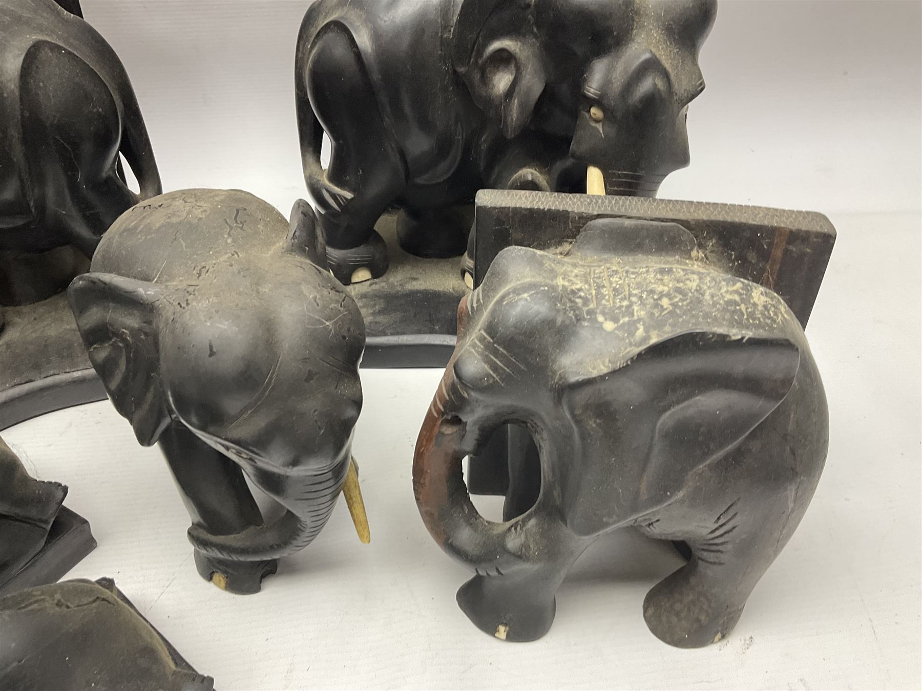 Three pairs of carved wooden elephant bookends, and a similar carved wooden elephant figure, tallest H24cm