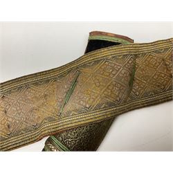 Late 19th century Yemeni Tuza jambiya as worn by religious elite, the 20.5cm curving blade with raised medial ridge, the horn hilt with pique style studwork, in a leather wrapped wooden scabbard with pierced metal mount and leather belt applied with embroidered 'gold' and 'silver' thread work panel; dagger L36cm overall, belt L84cm