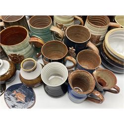 Wold studio pottery tankards, in various colours and relief decoration together with other studio items including vases, jugs and pots 