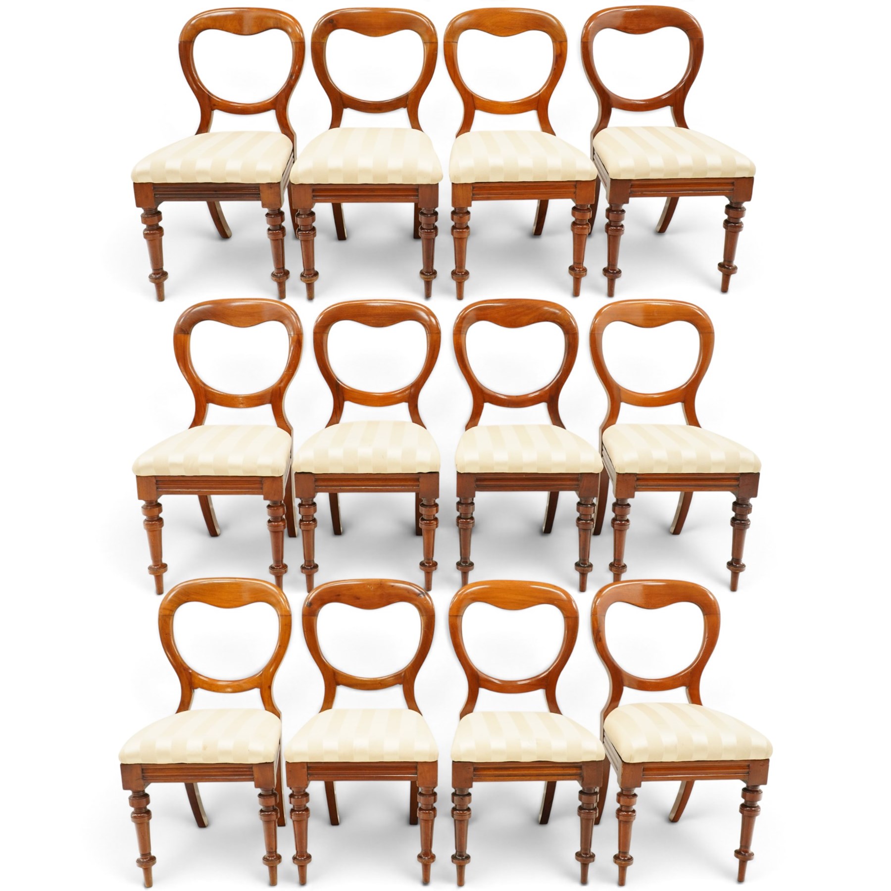 Set of twelve Victorian walnut balloon-back dining chairs, shaped open back over seats upholstered in striped ivory fabric, moulded seat rail above turned and tapering suppors