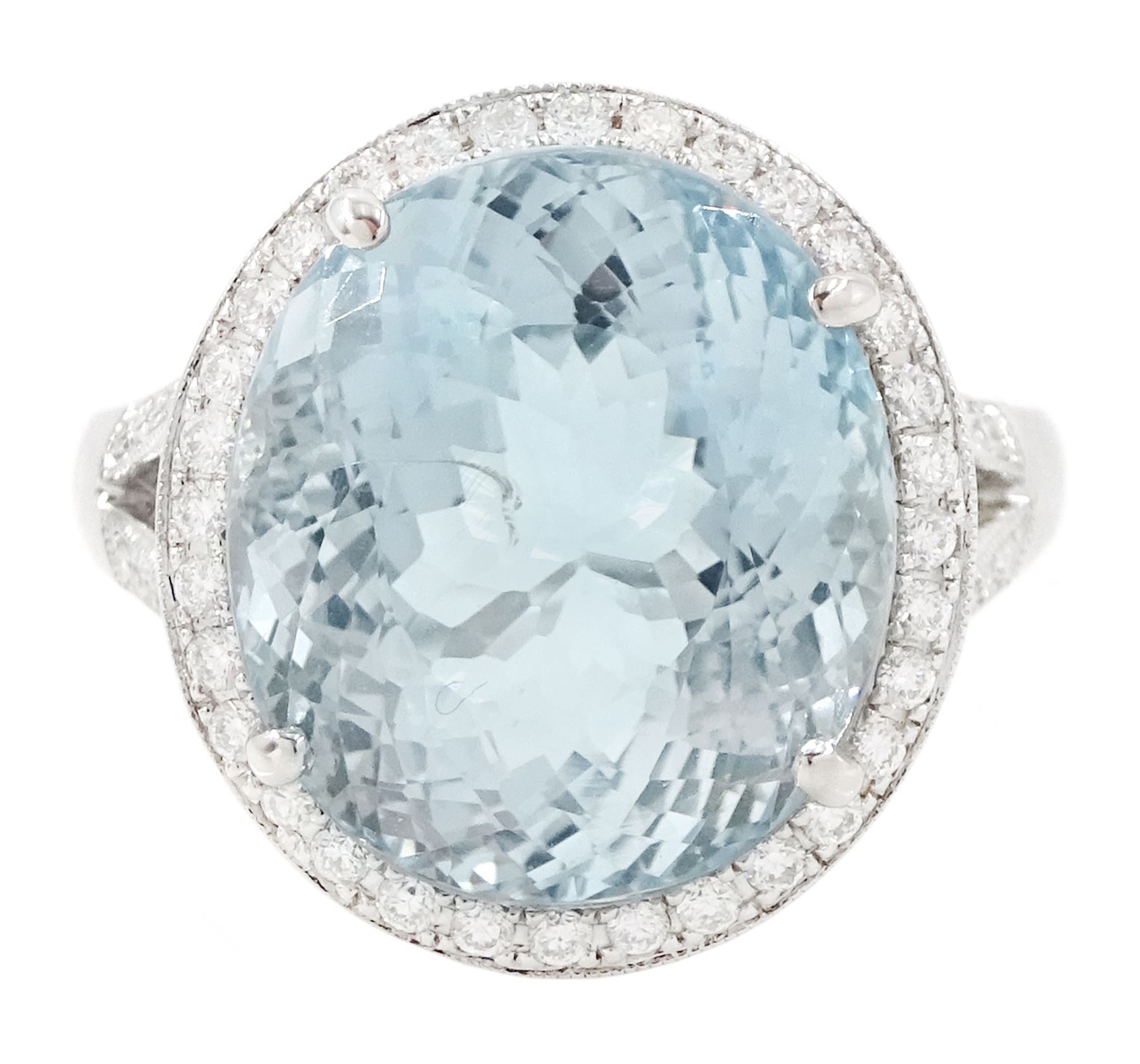 18ct white gold aquamarine and diamond cluster ring, single oval cut aquamarine of approx 8.20 carat, surrounded by milgrain set round brilliant cut diamonds, with diamond gallery and split diamond set shoulders, stamped 750, total diamond weight approx 0.30 carat