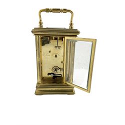 English - 20th century 8-day carriage clock, in a brass case with a white enamel dial, Roman numerals, minute track and steel moon hands, dial signed 