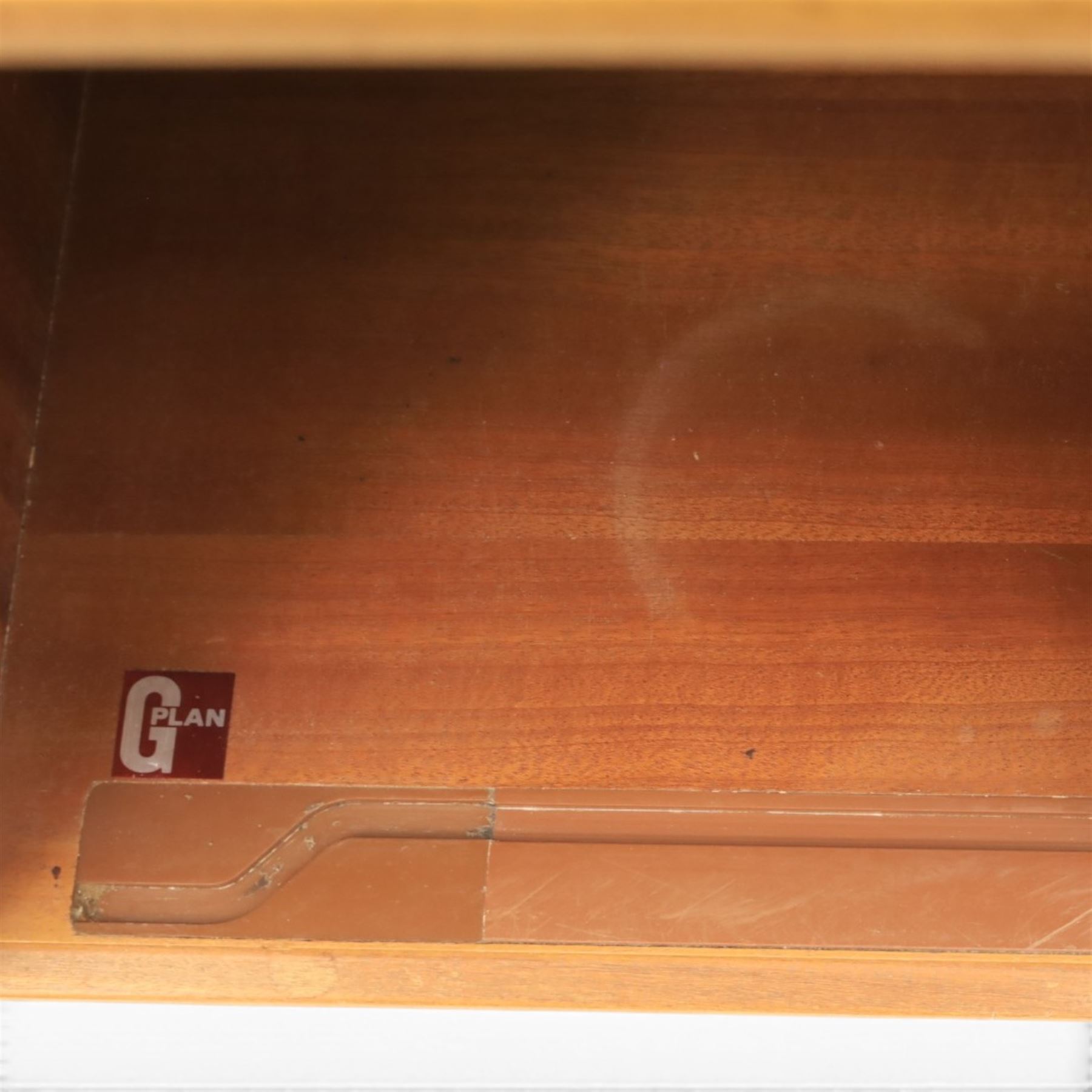 G Plan - Mid 20th century teak units, comprising tall shelving unit with cupboard sections, fall front and open shelves, together with a low twin-door cupboard unit, on plinth bases

Low unit: H 53cm, D 46cm, W 81cm
Tall unit: H 199cm, D 46cm, W 76cm