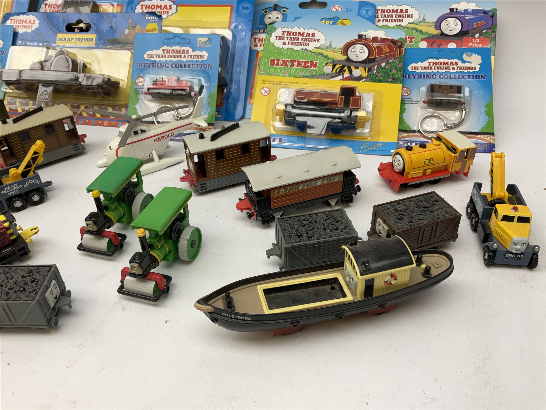 Ertl Thomas the Tank Engine and Friends die-cast models including carded Scrap Trevor, Slate Trucks, Neil, Wilbert, Sodor Taxi, Sodor Recovery Unit, Crane and four key rings; together with various uncarded models including locomotives, coal wagons, steam rollers, boat transporter, recovery units etc (over forty items)