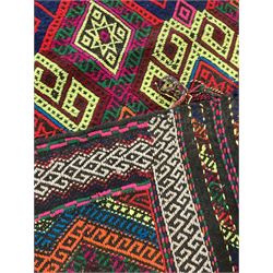 Flatweave geometric design rug, decorated with trailing hooked medallions within zig-zag bands, bright multi-coloured ground 