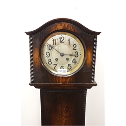  Early 20th century oak serpentine top grandmother clock, twin train movement striking the half hours on a gong, H125cm   