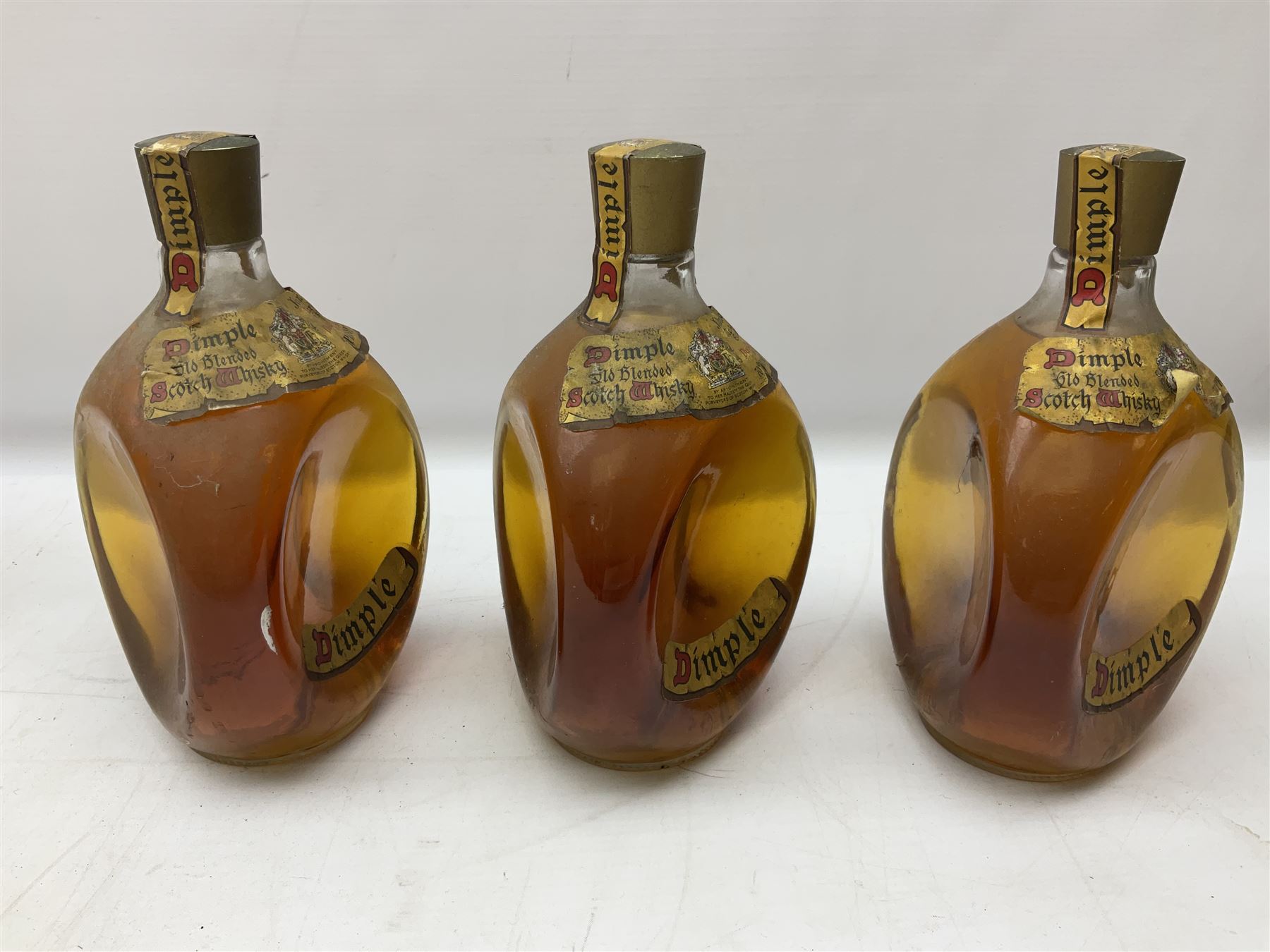 Four bottles of Haig's Dimple Old Blended Scotch whisky, all 26 2/3 Fl.OZs, 70 proof, one in original box and a bottle of East India 1961, Madeira, unknown contents and proof