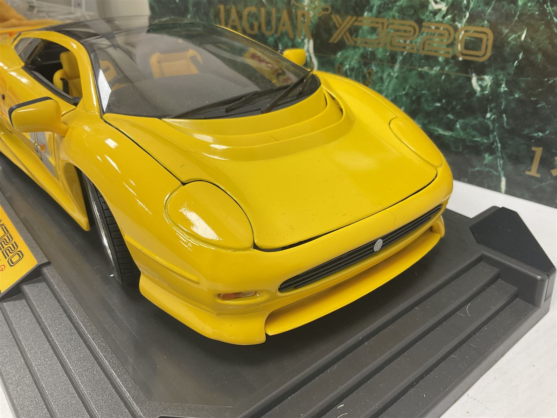 Two Maisto 1:12 scale Jaguar XJ220 ‘Racing’ cars in yellow, both on plinths in original boxes 