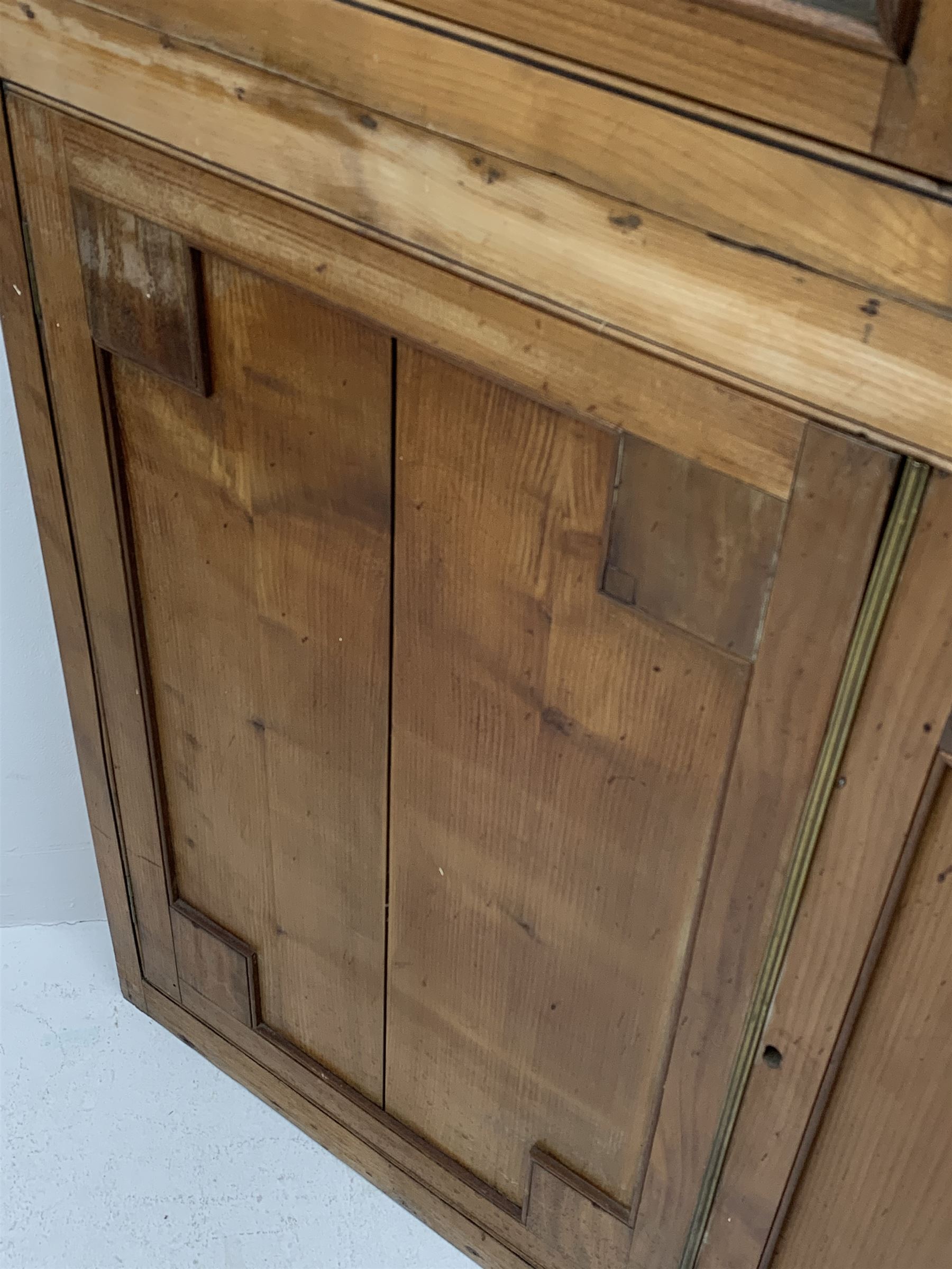 Large late 19th century sycamore corner cabinet, the top section with two astragal glazed doors enclosing two shaped shelves, the lower section enclosed by two panelled doors with square spandrels, W128cm, H215cm