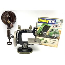 Dinky Kit No.1029 Ford D800 Tipper Truck in unopened original packaging; American Singer child's sewing machine; Spong's table mounting Bean Slicer No.632; and two wall mounting wooden die-cast model open display racks (5)