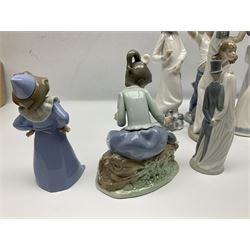 Eleven Nao figures to include Cowboy, Girl with Puppy, Clown, Girl in hat etc 