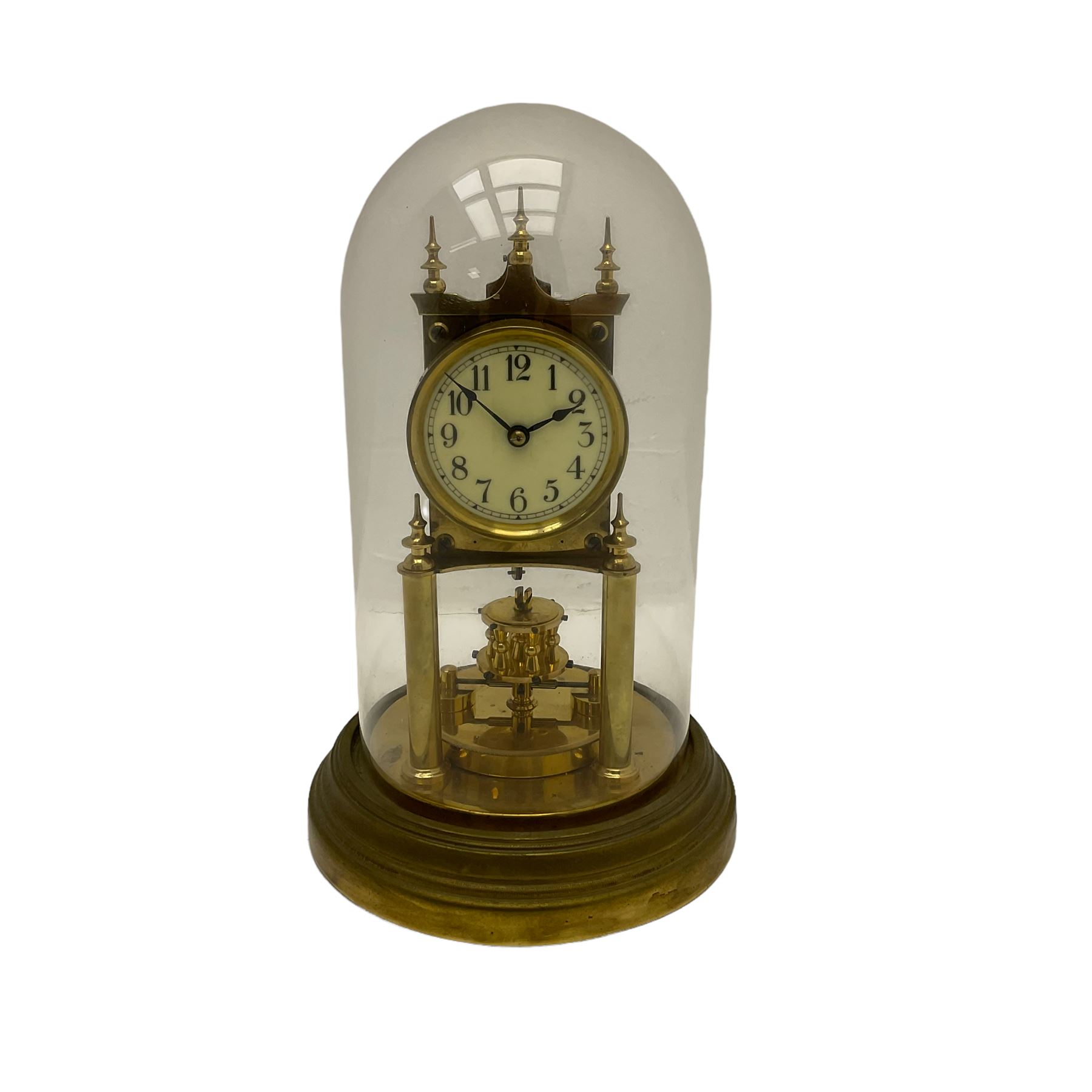 Gustav Becker 400-day torsion clock, serial No 2056379, with an adjustable rotary torsion pendulum and intact suspension, with a circular brass base and glass dome, cream enamel dial with roman numerals, minute markers and steel spade hands.

