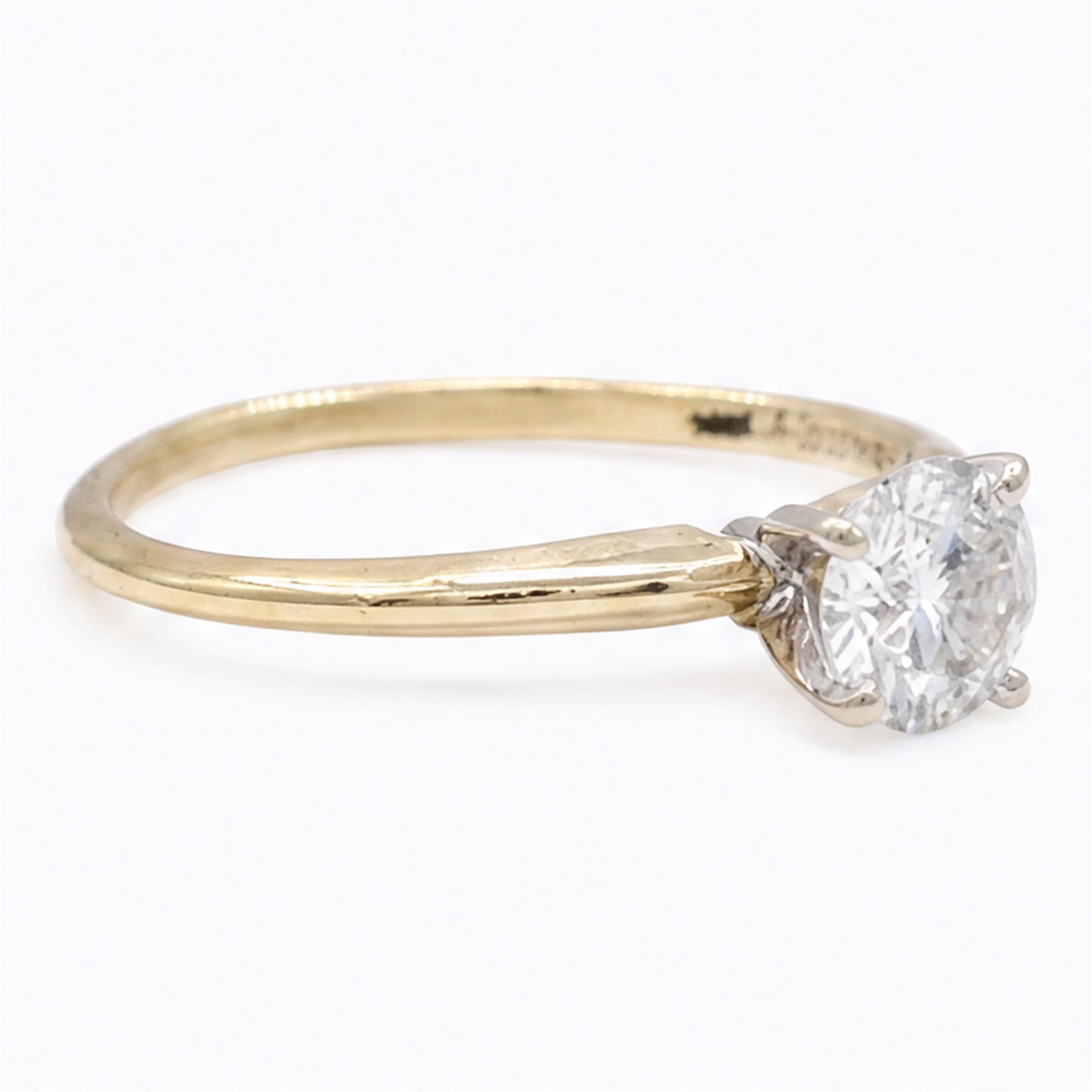 14ct gold diamond ring, four claw set with a single round brilliant cut diamond of 0.61 carat, stamped