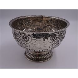 Late Victorian silver rose bowl, of circular form with embossed foliate and C scroll decoration, and engraved personal dedication, upon a part fluted spreading circular foot, hallmarked Wakely & Wheeler, London 1898, H11.5cm D18cm, approximate weight 11.67 ozt (363.2 grams)