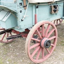 Western Covered Chuck Wagon

A large four wheeled covered wagon of timber construction, painted pale green with red painted wooden spoked wheels and a cream canvas tilt over an arched frame. The wagon has a traditional box body with covered rear compartment, front driving position, underbody turntable steering and iron fittings throughout. Fitted with external equipment details including a side mounted barrel, lidded storage chest, rope tie downs, horseshoe fittings and rear storage box.

Features

• Pale green painted timber body
• Cream canvas tilt over arched frame
• Covered rear compartment
• Front driving position
• Side mounted barrel
• External lidded storage chest
• Rear storage box
• Wooden spoked wheels
• Iron tyres
• Underbody turntable steering
• Rope tie downs
• Horseshoe fittings
• Iron hardware and brackets
• Brass restoration plaque to rear

Dimensions:
Overall length: 335 cm
Width: 170 cm
Height: 275 cm

Wheel Diameters:
Front wheels: 92 cm
Rear wheels: 112 cm

Seating:
Driver: 1
Passenger: Rear covered compartment