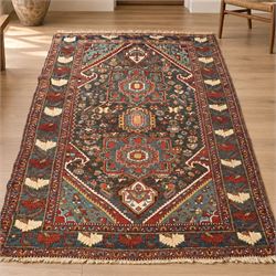 Antique Persian Qashqai dark indigo ground tribal rug, the busy field decorated with a geo...