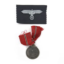 Third Reich SS officers cap insignia, machine-woven silver bullion SS Eagle, on black rectangle, together with German Eastern Front Medal, insignia H5cm, L7cm 