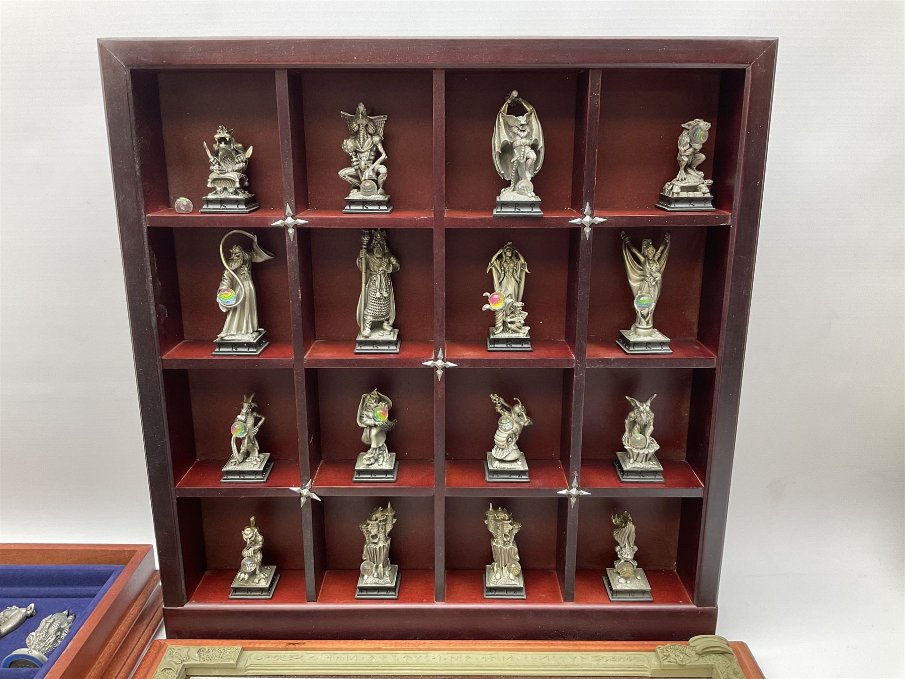 Danbury Mint 'The Fantasy of the Crystal' chess set consisting of mythical pewter chess pieces within a wooden case with chess board lid, together with 16 additional chess pieces in a wooden display case.