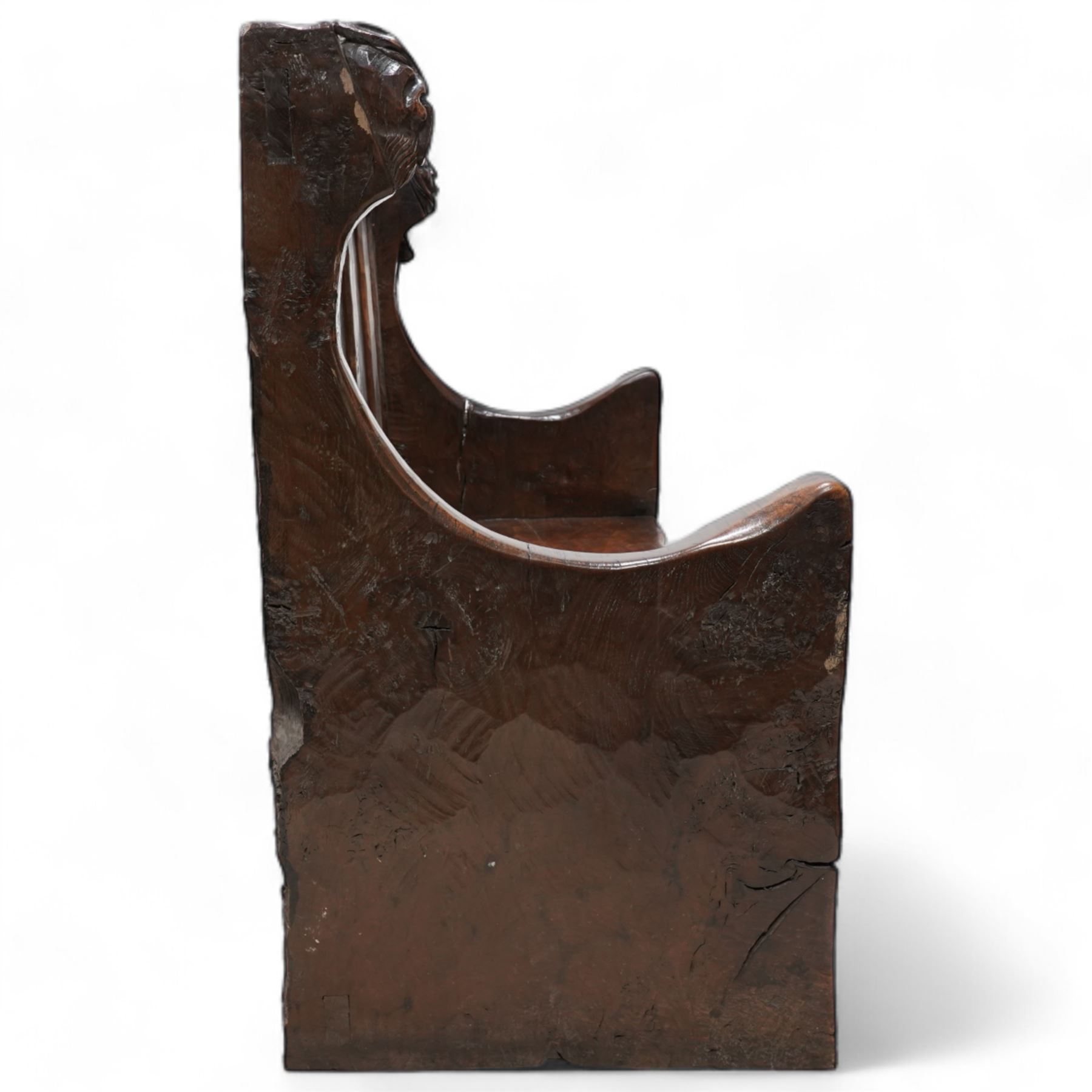 Mouseman - circa. 1920s adzed oak settle or bench, the cresting rail carved with inscription 'Before Honour is Humility', four panel back and plank seat on shaped end supports carved with grotesque masks terminals, carved with mouse signature, by Robert Thompson of Kilburn 

