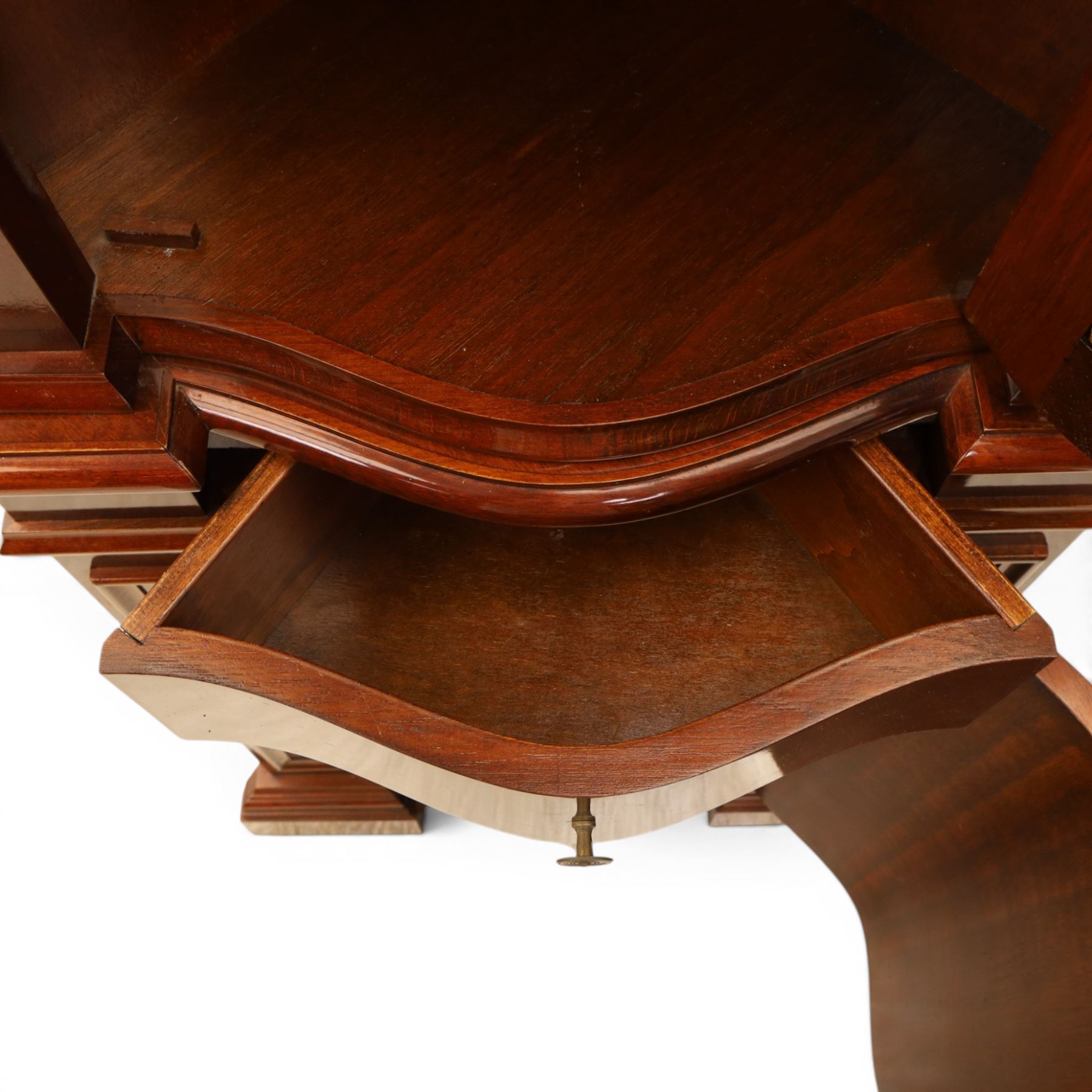 Victorian design mahogany corner cabinet, shaped carved cresting above bowed glazed upper door, with panelled side uprights, lower drawer over cupboard door decorated with floral marquetry, on plinth base