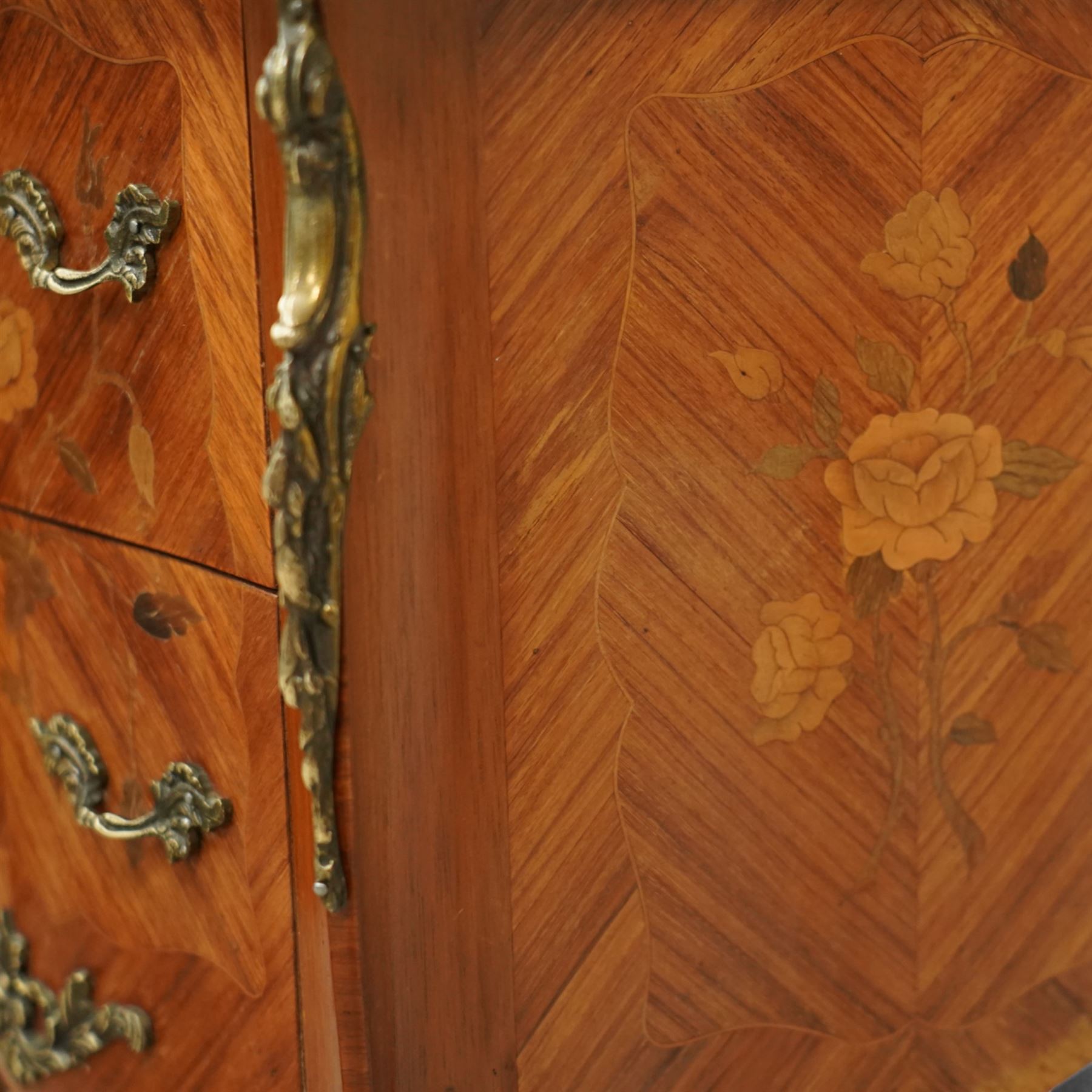 Pair of early 20th century French marquetry bedside cabinets, each serpentine marble top above two drawers with floral inlay, ormolu mounts and handles, on slender cabriole supports with sabots