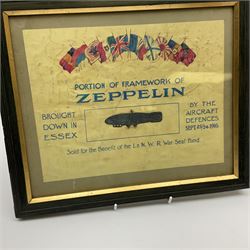 Framed WW1 fund raising souvenir entitled 'Portion of Framework of Zeppelin Brought Down in Essex by the Aircraft Defences Sept.23/24 1916 - Sold for the Benefit of the L. & N.W.R. War Seal Fund', being a piece of metal formed in to the shape of an airship, 20 x 26cm; and a WW1 Trenchart brass table lamp base made from a crushed and pierced Russian shell case inscribed 1914 H17cm including fitting (2)