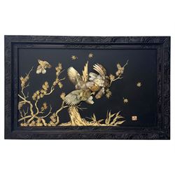 Meiji period (1868–1912), signed Shibayama carved hardwood lacquer panel inlaid with mother-of-pearl and ivory, decorated in high relief and inlaid, depicting two birds of prey with locked talons and beaks on leafy tree branch, signature in lower right corner, in original frame. This item has been registered for sale under section 10 of the APHA Ivory Act