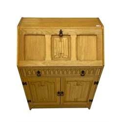 Light oak bureau, fall front above single drawer and two cupboards, carved linenfold detail