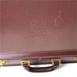 Loewe - vintage burgundy leather attaché case, the exterior embossed with Loewe Anagram, with gilt-tone hardware, twin combination locks and leather handle, opening to a suede-lined fitted interior with document compartments, pen loops and pockets, stamped LOEWE Madrid 1846