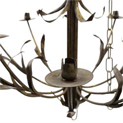 Early 20th century wrought iron and gilt metal twelve-light candle chandelier, with scrolling branches, stylised leaf decoration and chain suspension