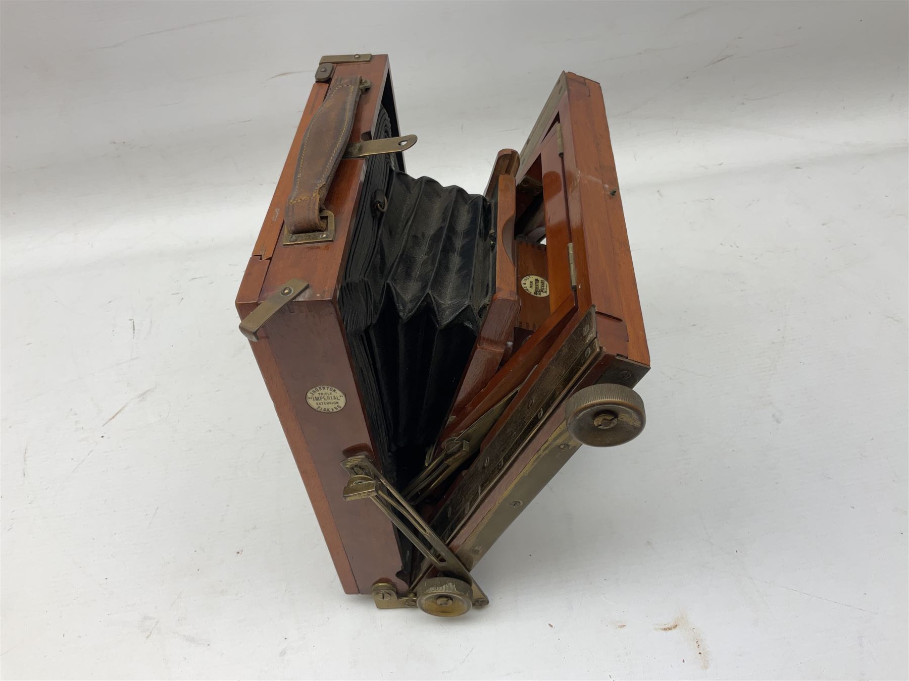 Thornton Pickard Imperial Triple folding plate camera in mahogany and lacquered brass, field model, three mahogany photographic plates and a wooden tripod