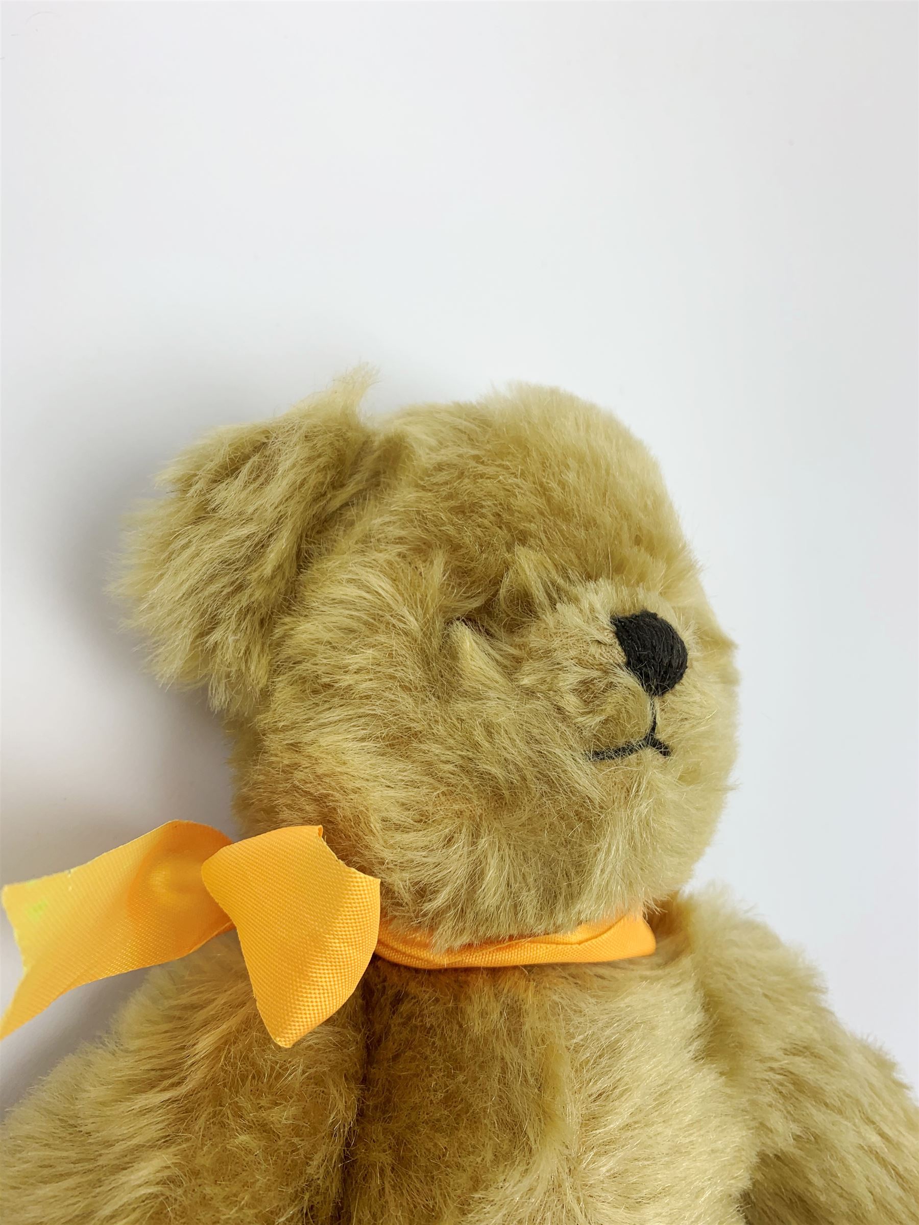 Chad Valley Hygienic Toys teddy bear c1950, kapok filled mohair plush body with original factory given yellow neck ribbon, jointed limbs with velvet paw pads, glass eyes and vertically stitched nose and mouth, blue/white printed label to side seam H12