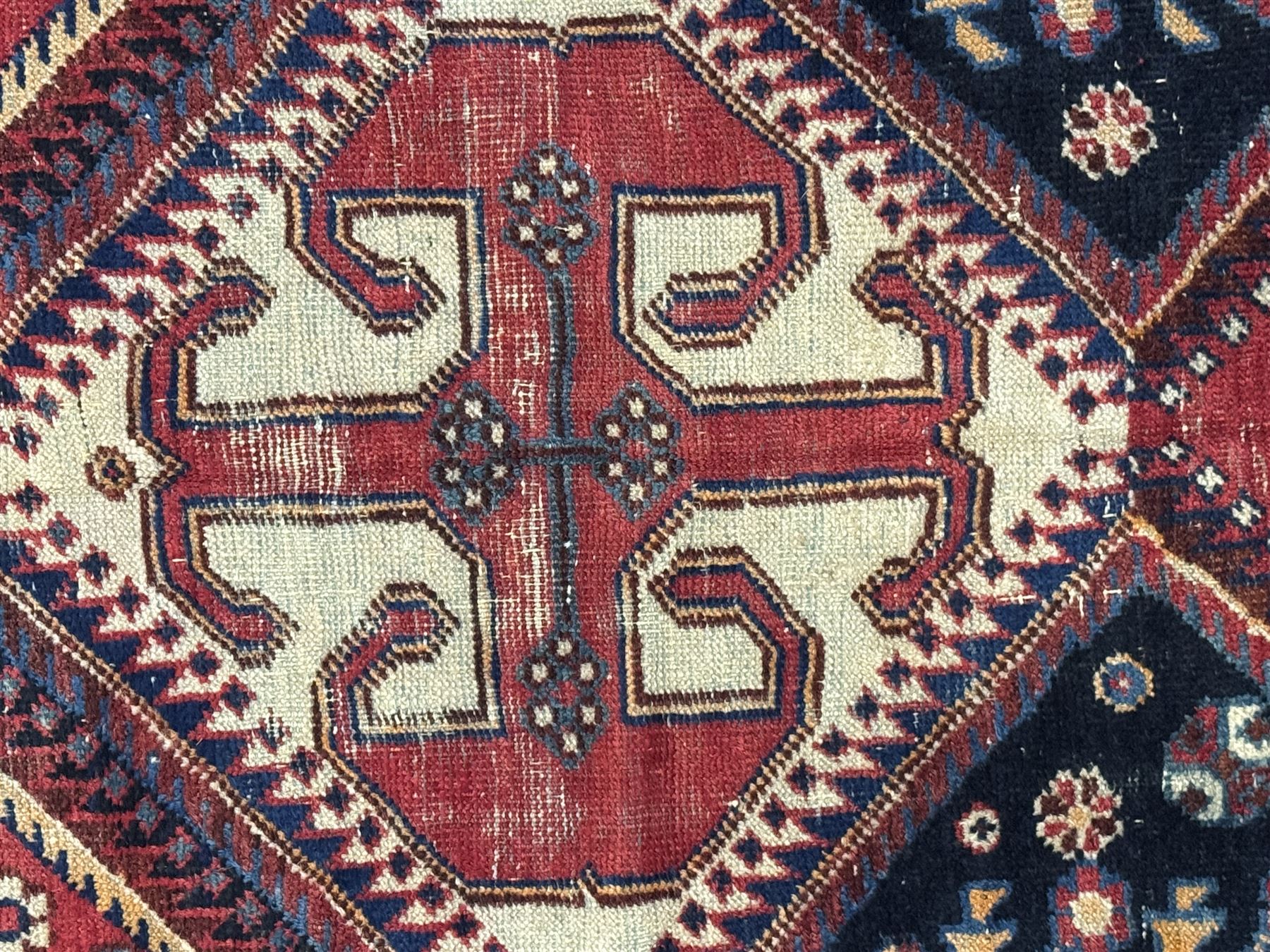 Persian Heriz wool rug, red and ivory field with floral medallion, geometric spandrels, and floral border (157cm x 107cm); Kurdish Shairwan wool rug, red and navy field with three medallions, geometric crosses and serrated border (200cm x 155cm); Persian Qashqai wool rug, golden-yellow field with boteh motifs and wide floral border (127cm x 82cm)
