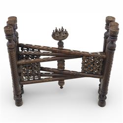 20th century Eastern brass charger topped table, the circular brass trap chased with an elephant, palm tress and flowering vines, supported upon a folding stand with six turned legs with inlaid detail, united by turned supports