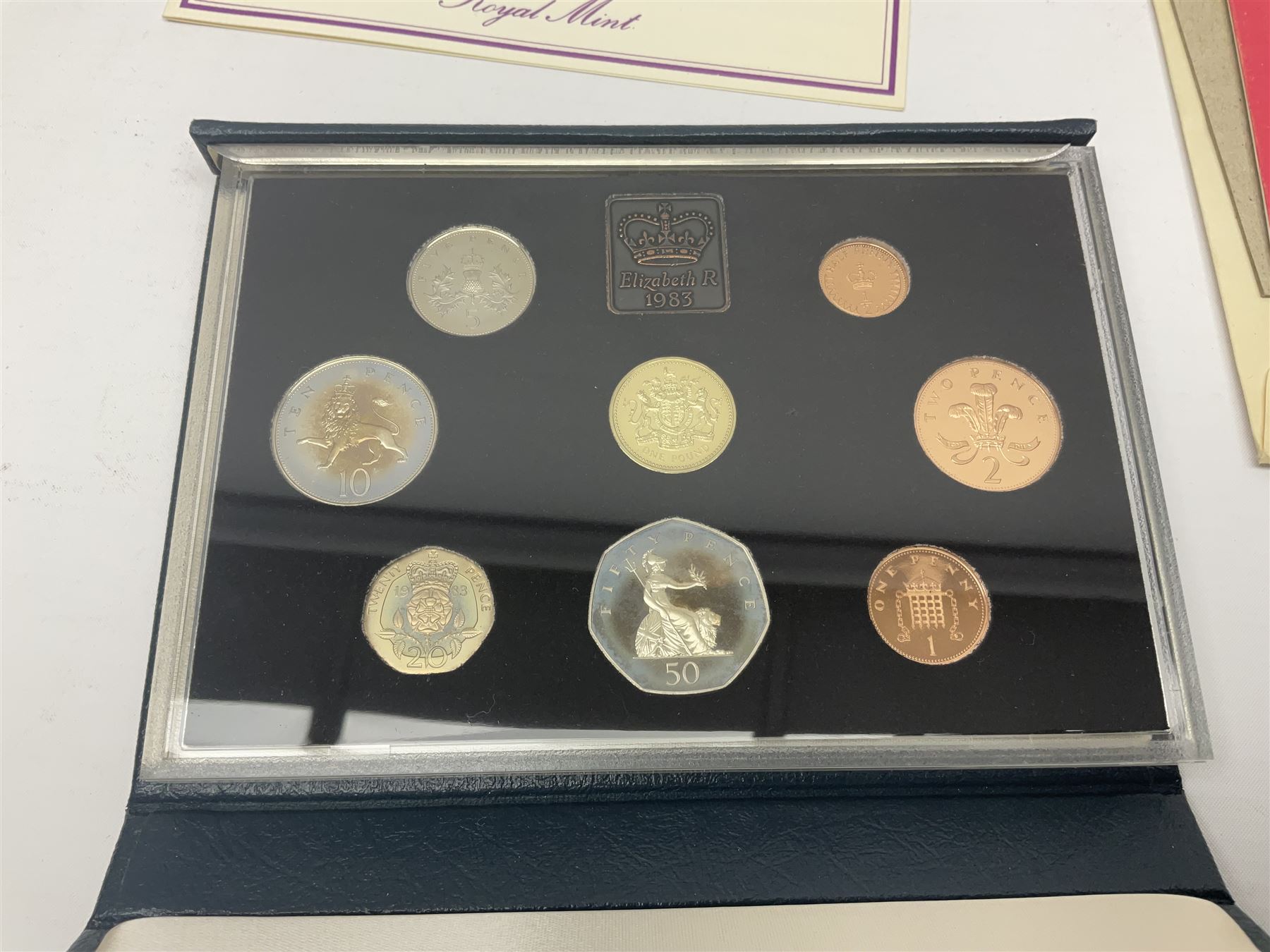 The Royal Mint United Kingdom 1983 proof coin collection in blue folder with certificate, 1983 uncirculated coin collection, two 1987 brilliant uncirculated coin collections, commemorative crowns etc