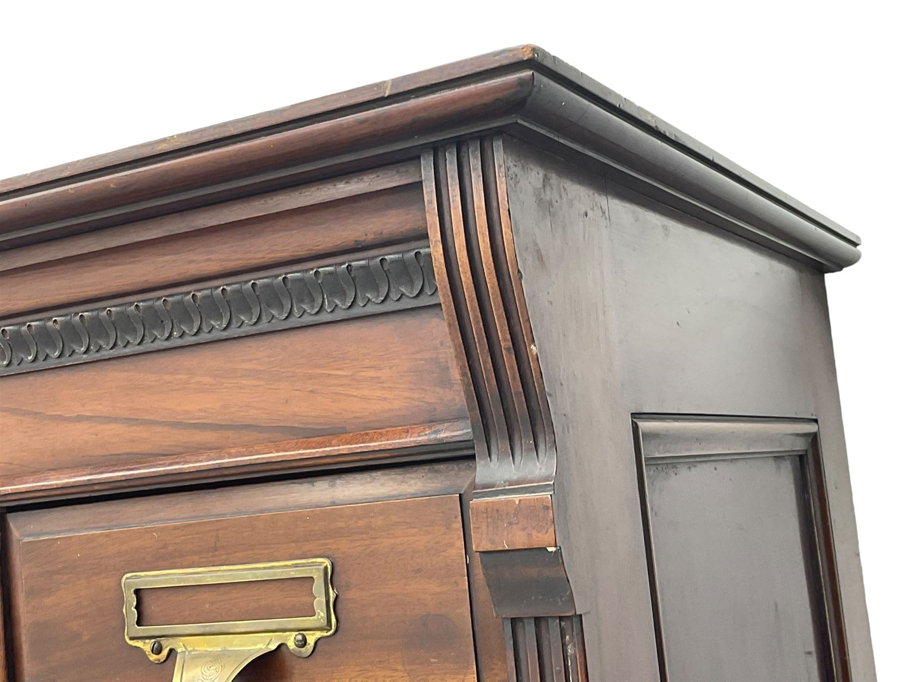 The Shannon Limited - late Victorian walnut filing cabinet, fitted with twenty-four small filing drawers, each with brass handle with label holder, fluted uprights, double cupboard below enclosed by two panelled doors, on turned feet, with brass plaque inscribed 'The Shannon, Limited, Ropemaker St. London, E.C.'