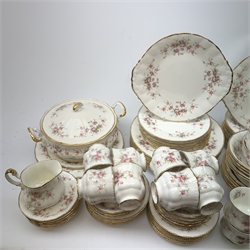 Paragon Victoriana Rose pattern tea and dinnerware, comprising fourteen teacups, sixteen saucers, fourteen side plates, two milk jugs, two open sucriers, two sandwich plates, a cake stand (lacking central support), two tureen and covers, eight dinner plates, twenty one dessert plates, eleven bowls, and sauce boat and stand. 