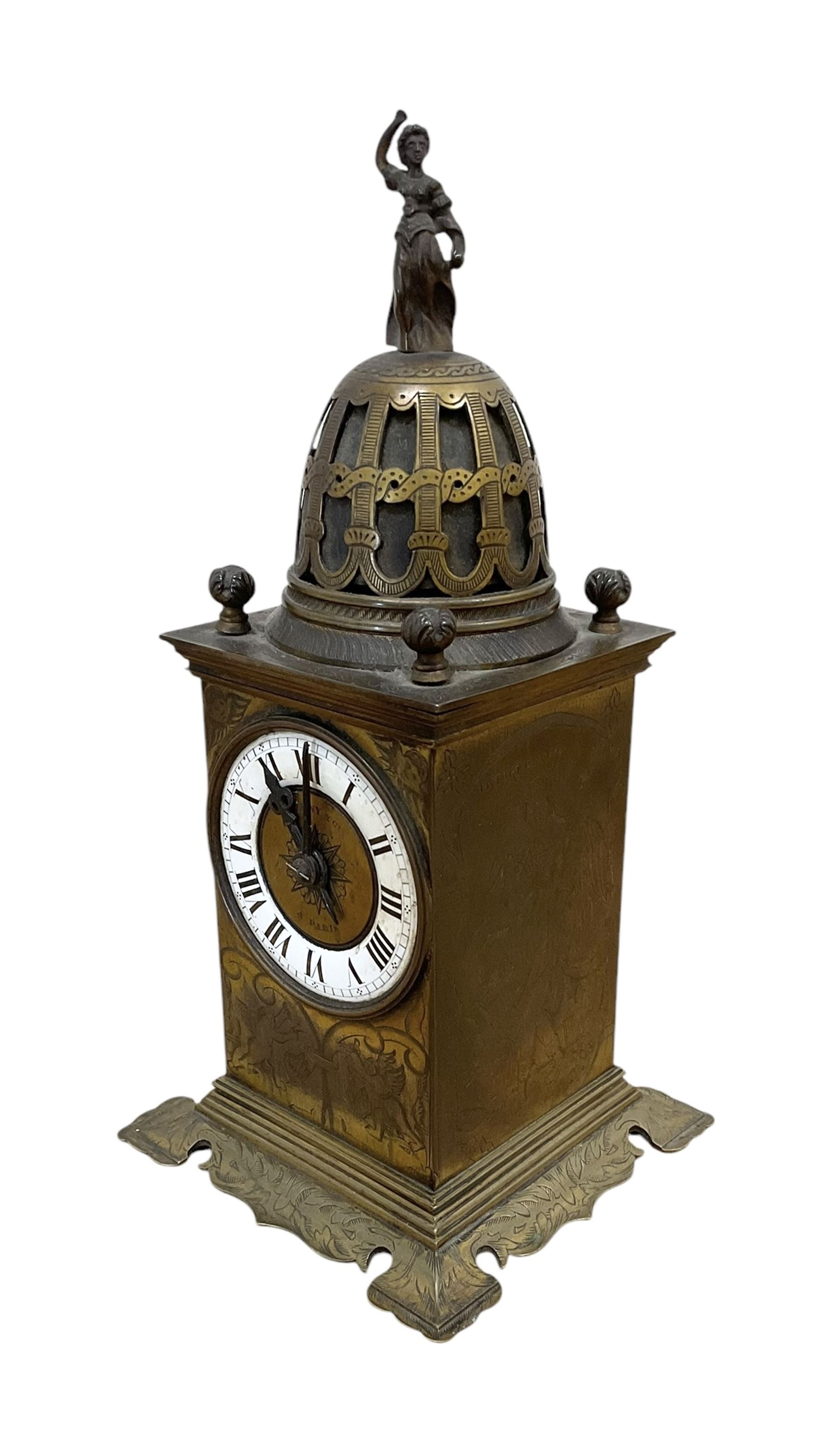 Tiffany- early 20th century brass cased 8-day mantle clock, rectangular case with engraved images taken from classical & mythological fables, with an open strapwork dome, finials to the corners and a cast figure of a standing maiden, case raised on a splayed base with acanthus engraving, enamel dial with Roman numerals, minute markers and steel hands, dial centre engraved Tiffany & Co Paris, twin train French movement with a platform escapement wound from the rear, baseplate of case stamped with the serial numbers 4372 & 5652. With key. 
Provenance from Chatsworth House, Derbyshire.