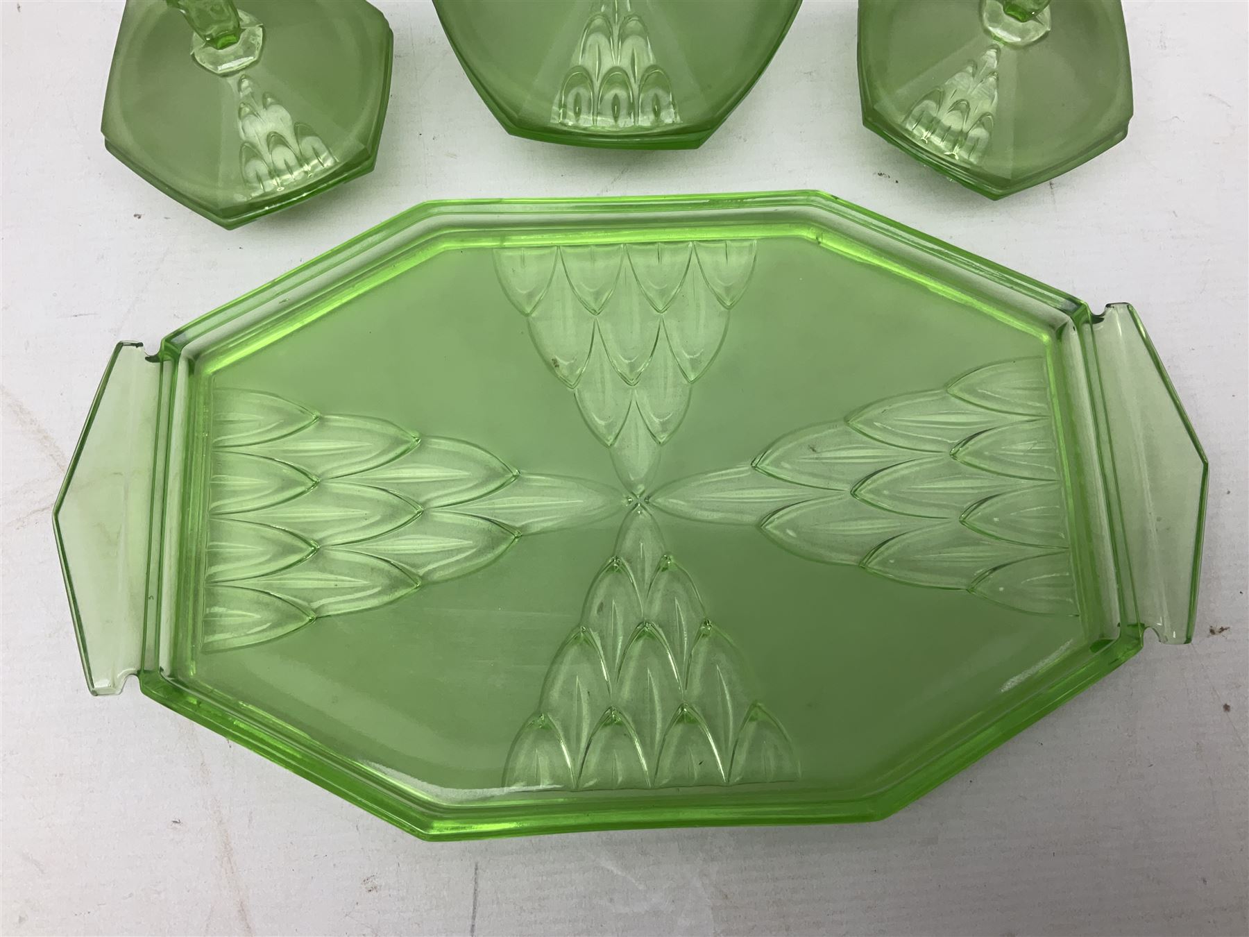 Czech uranium glass dressing table set, comprising twin handled tray, pair of candlesticks, three lidded jars and ring holder dish, and a blue Finnish Riihimäki glass, tray L35cm