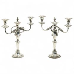 Pair of silver plated three branch candelabra with scroll branches and circular bases H35cm 