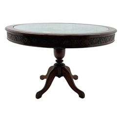 Pakistan carved hardwood brass inlaid circular dining table, and four rail back chairs with saddle seats