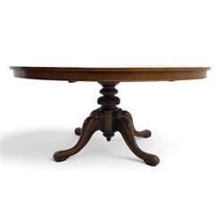 Victorian mahogany breakfast loo table, oval tilt-top on turned pedestal, quatrefoil out-splayed carved supports, scroll carved terminals with brass castors