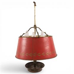 Bouillotte lamp, the adjustable red tole shade above three brass sconces upon a circular d...