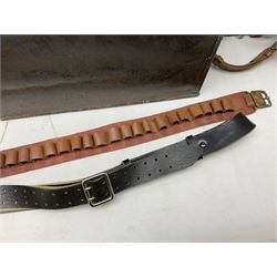 Assorted militaria including ten leather or canvas cartridge and other belts, maroon beret with 17th Lancers cap badge, modern bullet mould, leather and brass shot flask, two knives, shell cases, boomerang etc; in tin deed box