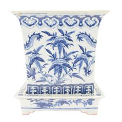 Chinese blue and white planter and stand, each of square slightly tapering and flared form, the planter decorated with two dragons and blossoming peonies, between stylised borders, the stand decorated with flower heads and vines, planter H30cm W29cm, stand H7cm D28.5cm