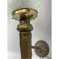 Two 20th century brass wall lights of torch form, with opaque moulded glass flame shades, largest L67cm