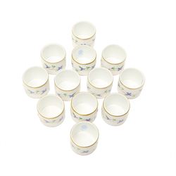 Set of twelve Herend porcelain napkin rings painted with trailing flowers and leaves on a moulded ground