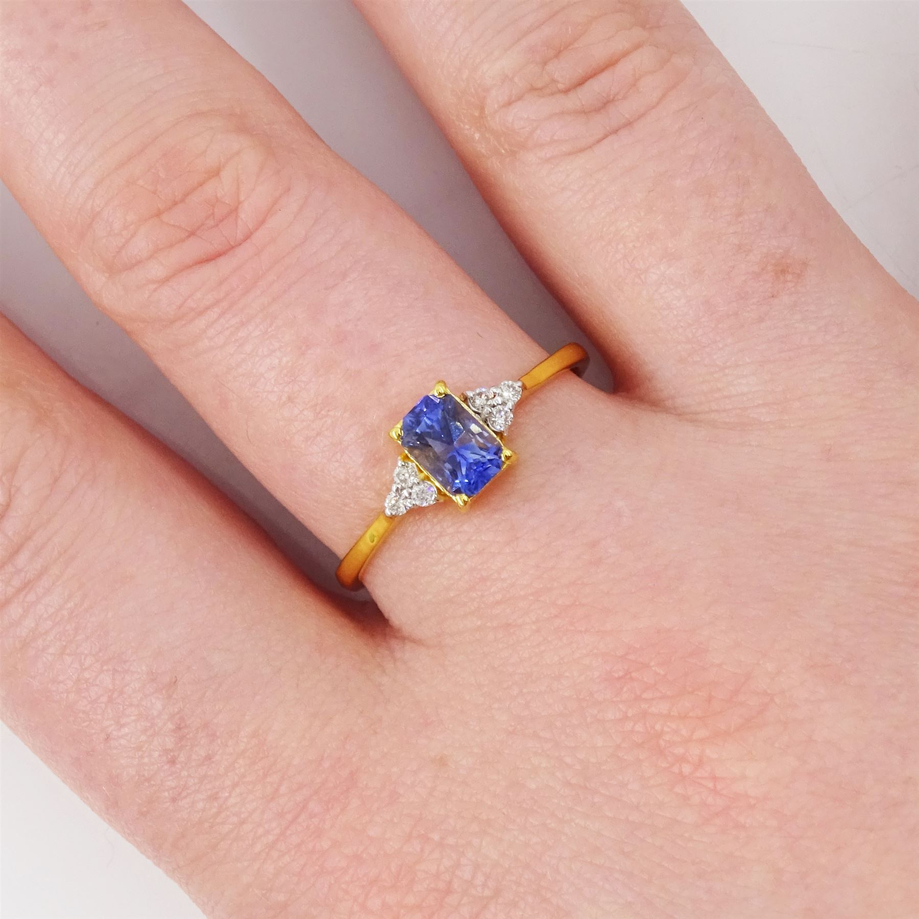 14ct gold Ceylon sapphire and diamond ring, single radiant cut sapphire of approx 0.75 carat, with three round brilliant cut diamonds set either side, stamped