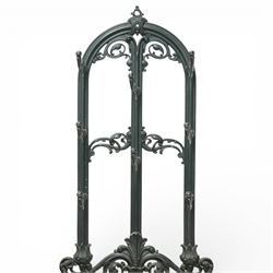 Late 19th century cast iron stick stand, the arched back with scrolling foliate decoration, fitted with multiple hooks, the lower section with pierced panels centred by a radiating sunburst motif, raised on a rectangular drip tray base